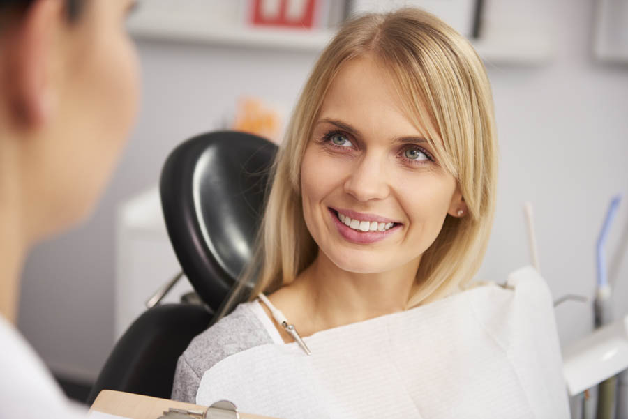 Pleased and smiling woman in dentist's clinic