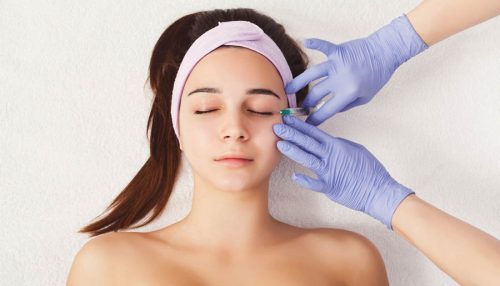 Woman getting beauty injection at salon